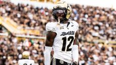 Travis Hunter (12) of the Colorado Buffaloes smiles after a play against the UCF Knights at FBC Mortgage Stadium on September 28, 2024 in Orlando, Florida.